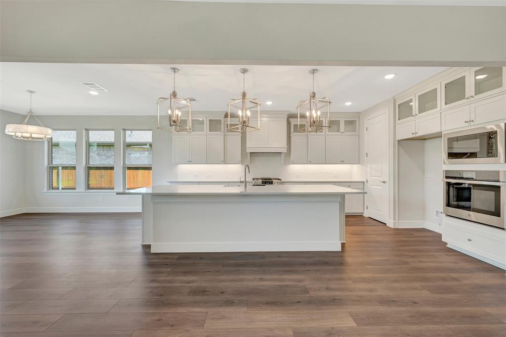11460 Wulstone Road Fort Worth, TX 76052 - Photo 8 of 40 a view of a kitchen with kitchen island stainless steel appliances counter space