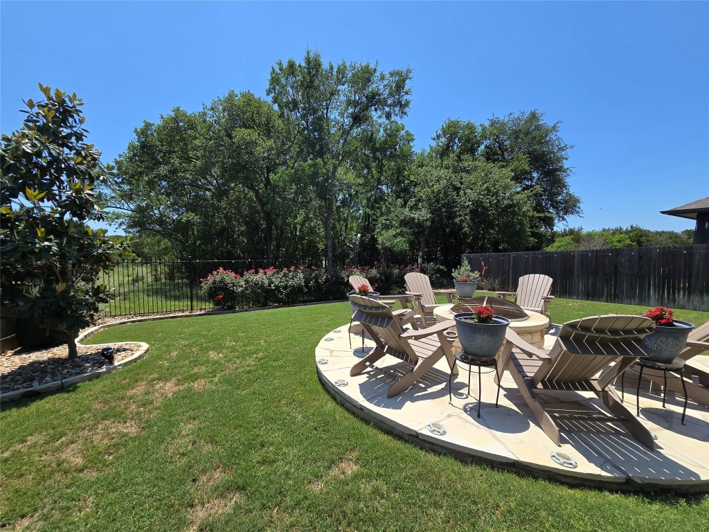 a backyard of a house with table and chairs