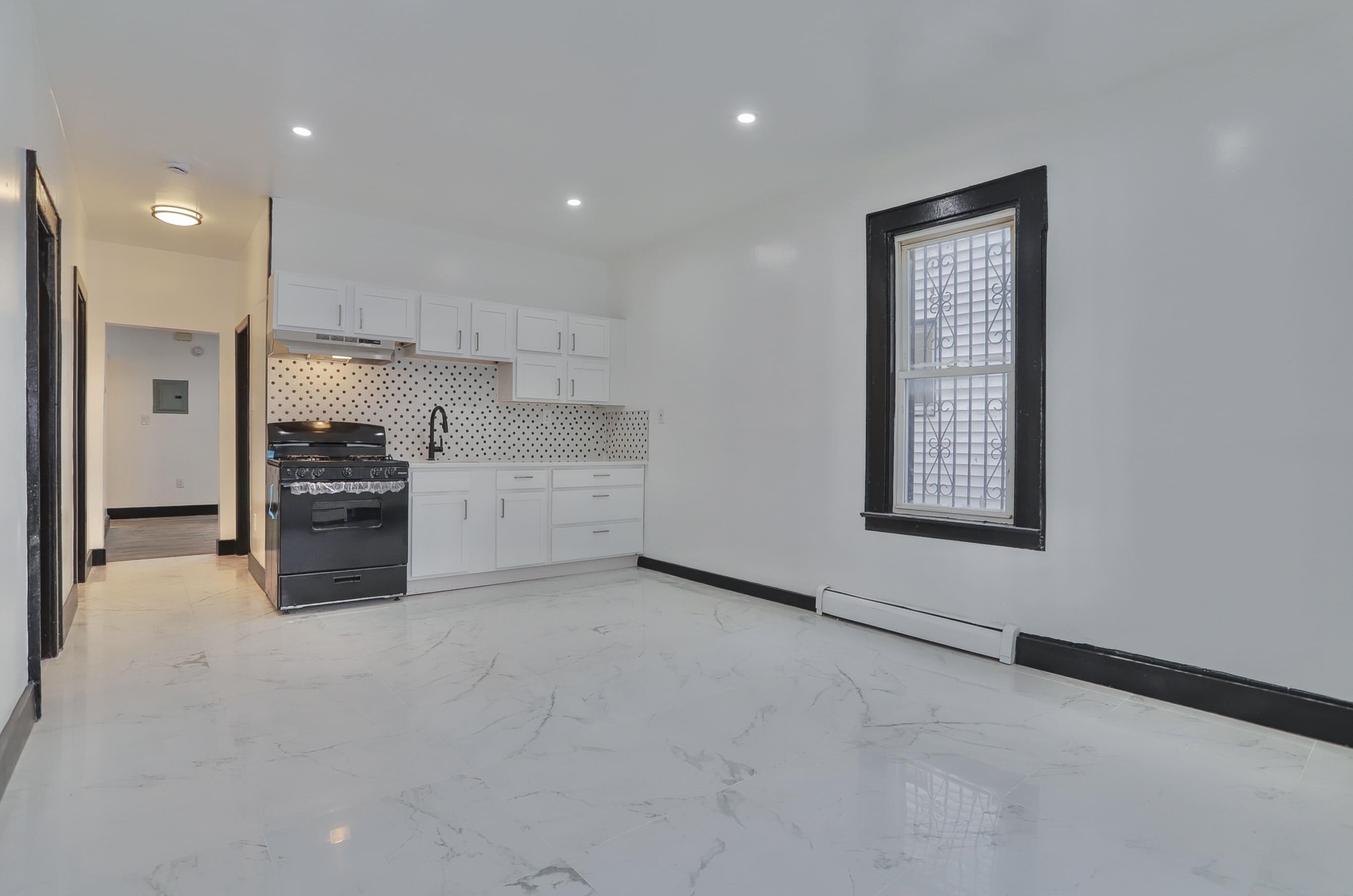 445 South 15th Street Newark, NJ 07103 - Photo 12 of 41 a kitchen with stainless steel appliances a refrigerator and a stove top oven