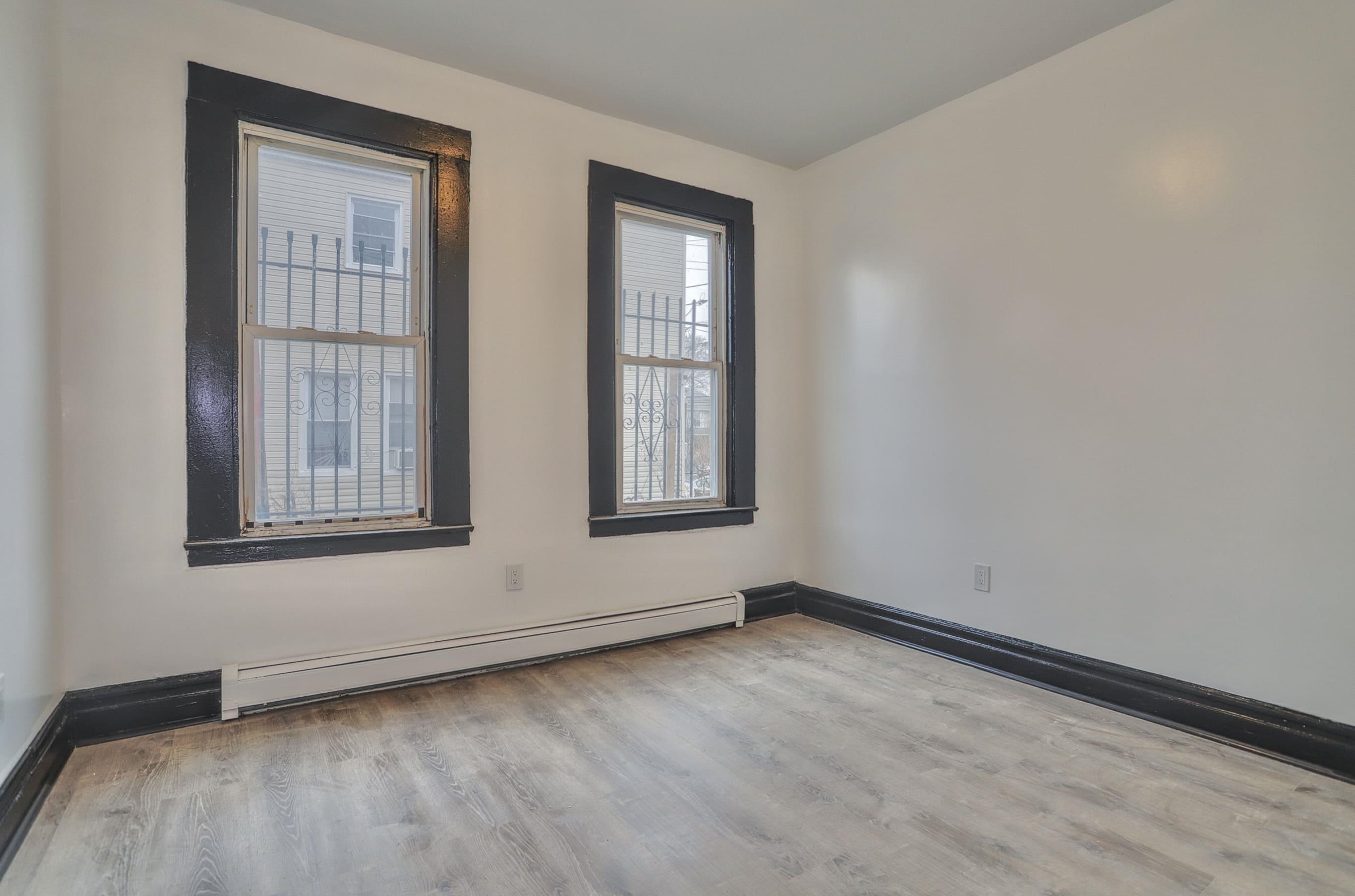 445 South 15th Street Newark, NJ 07103 - Photo 19 of 41 a view of an empty room with wooden floor and window