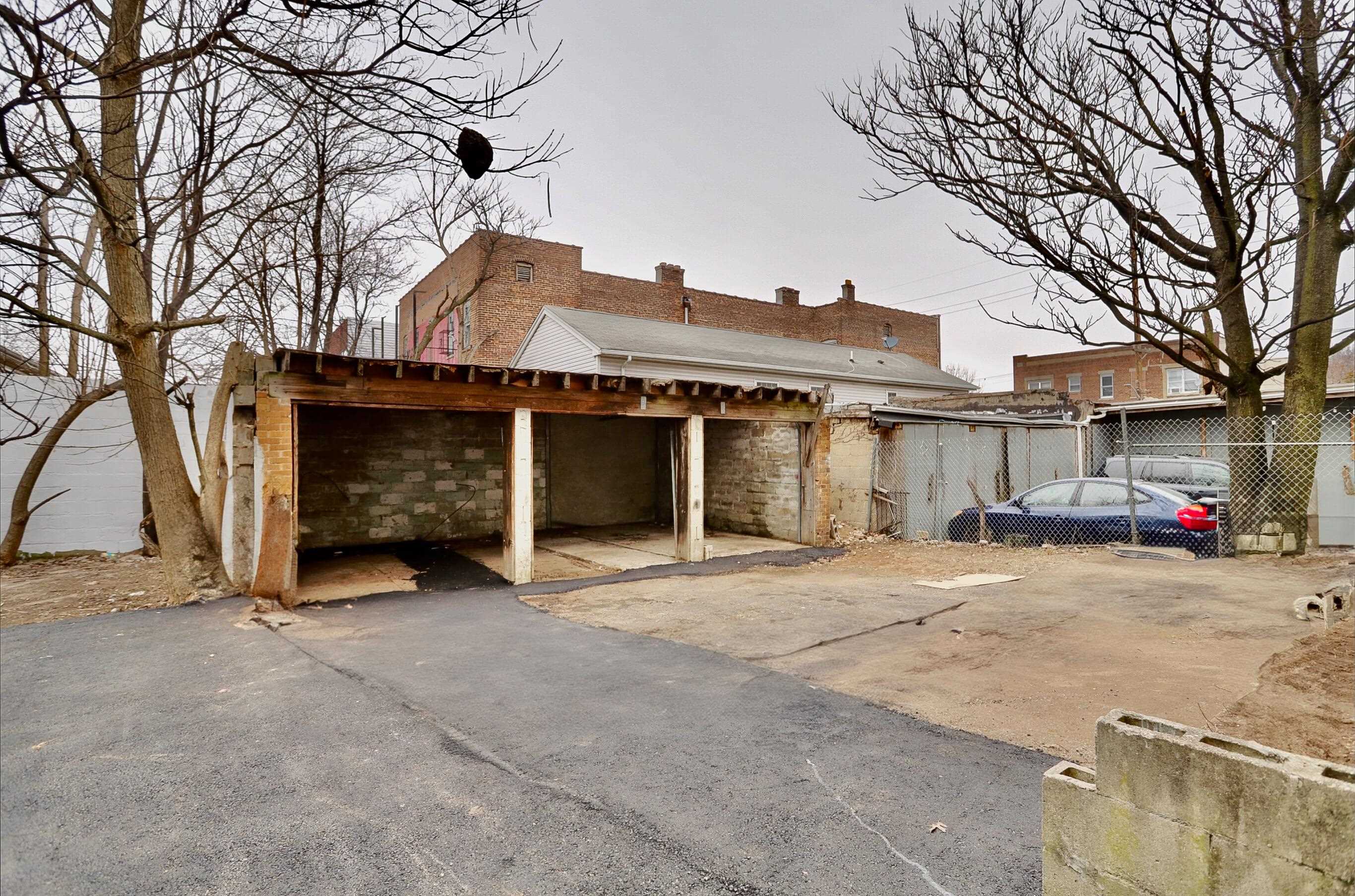 445 South 15th Street Newark, NJ 07103 - Photo 4 of 41 a view of a house with a yard and garage