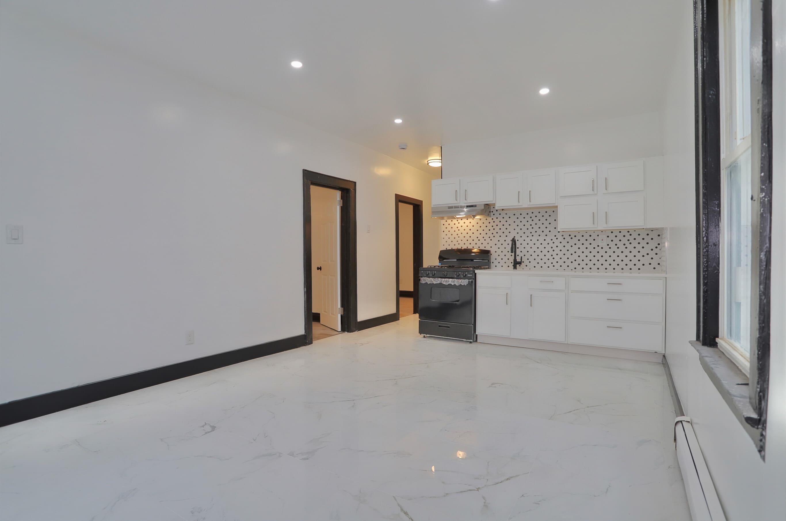 445 South 15th Street Newark, NJ 07103 - Photo 10 of 41 a view of a kitchen with a sink and dishwasher a refrigerator with white cabinets