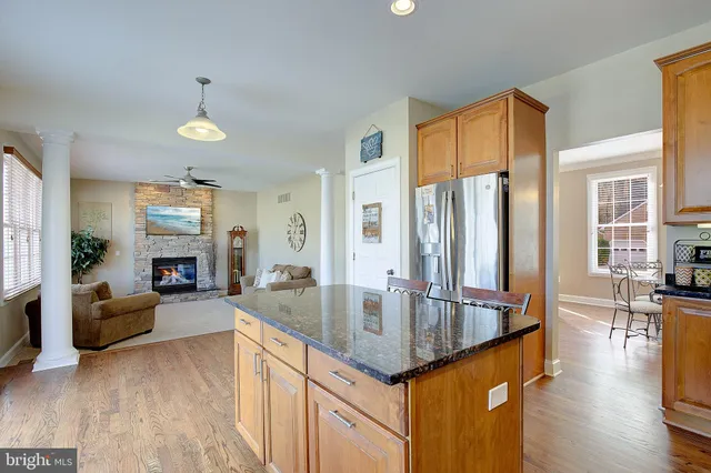 a living room with furniture a fireplace and a large window
