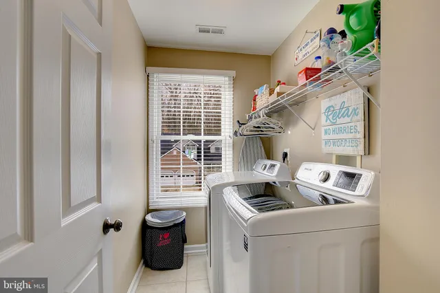 a kitchen with stainless steel appliances granite countertop a refrigerator a stove top oven a sink and dishwasher with wooden floor