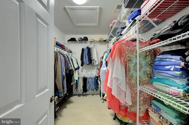 a kitchen with stainless steel appliances granite countertop wooden floors and white cabinets