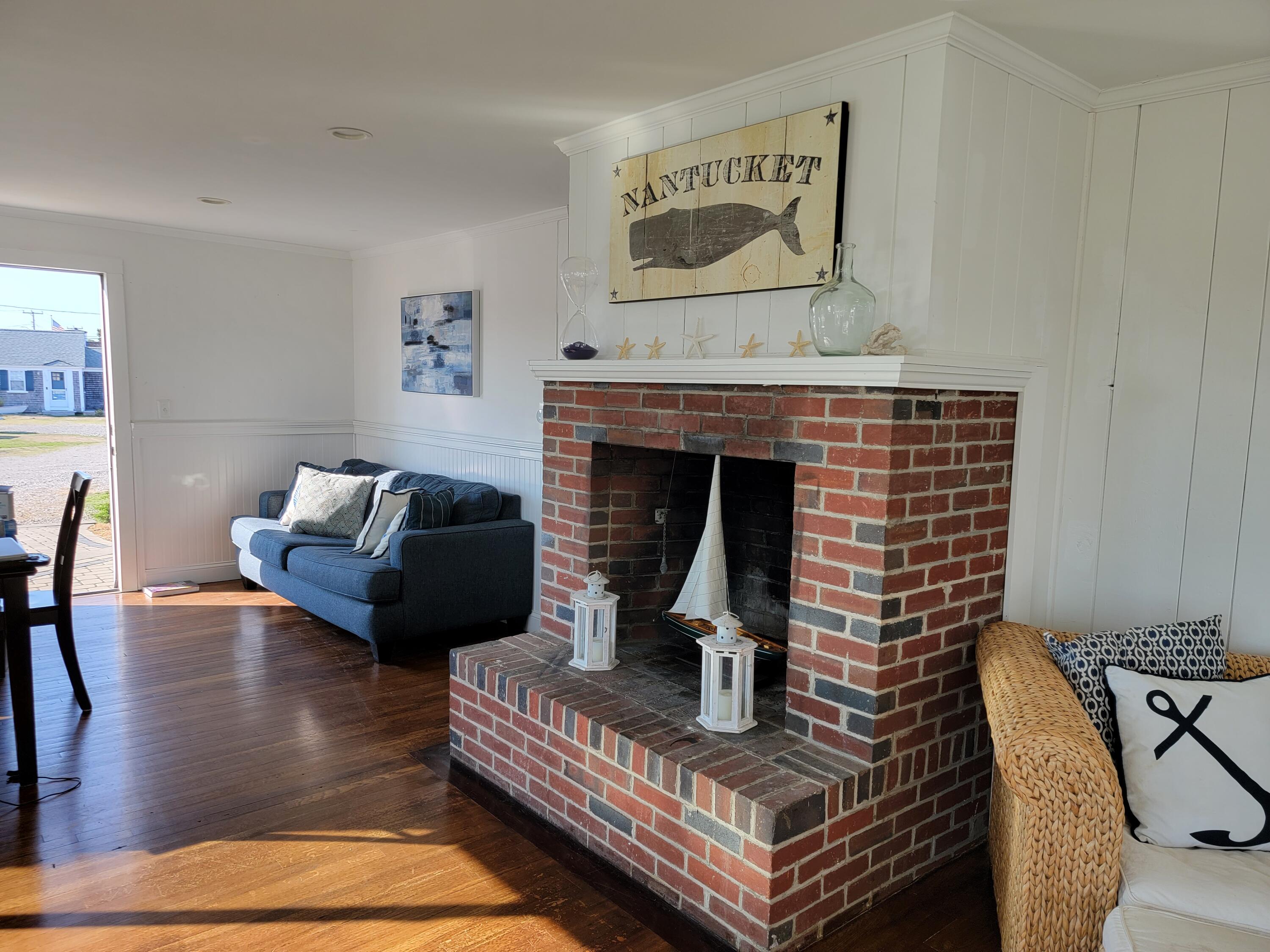 1060 Craigville Beach Road Centerville, MA 02632 - Photo 11 of 50 a living room with furniture and a fireplace