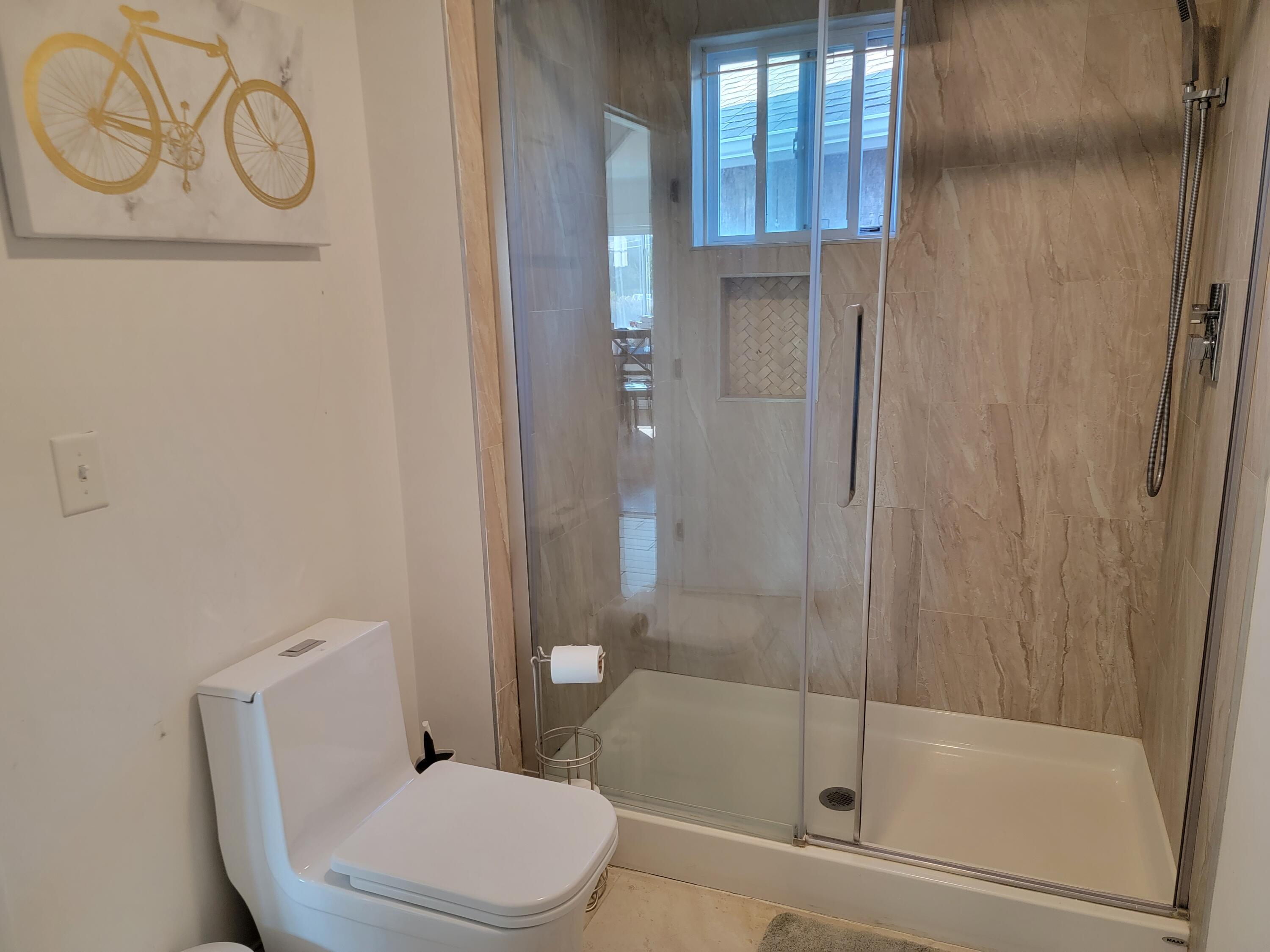 1060 Craigville Beach Road Centerville, MA 02632 - Photo 12 of 50 a white toilet sitting next to a bathroom sink