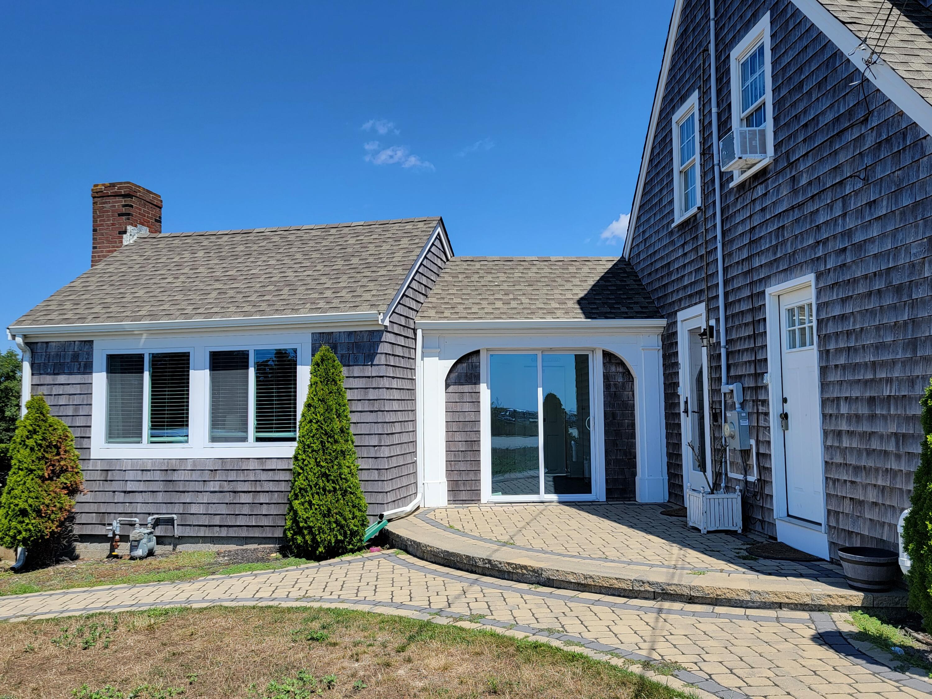 1060 Craigville Beach Road Centerville, MA 02632 - Photo 15 of 50 a front view of a house with a yard