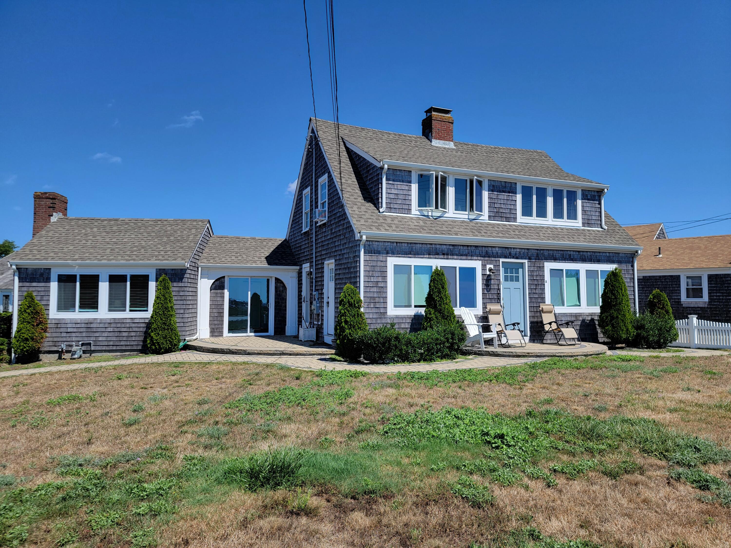 1060 Craigville Beach Road Centerville, MA 02632 - Photo 2 of 50 a front view of a house with a yard