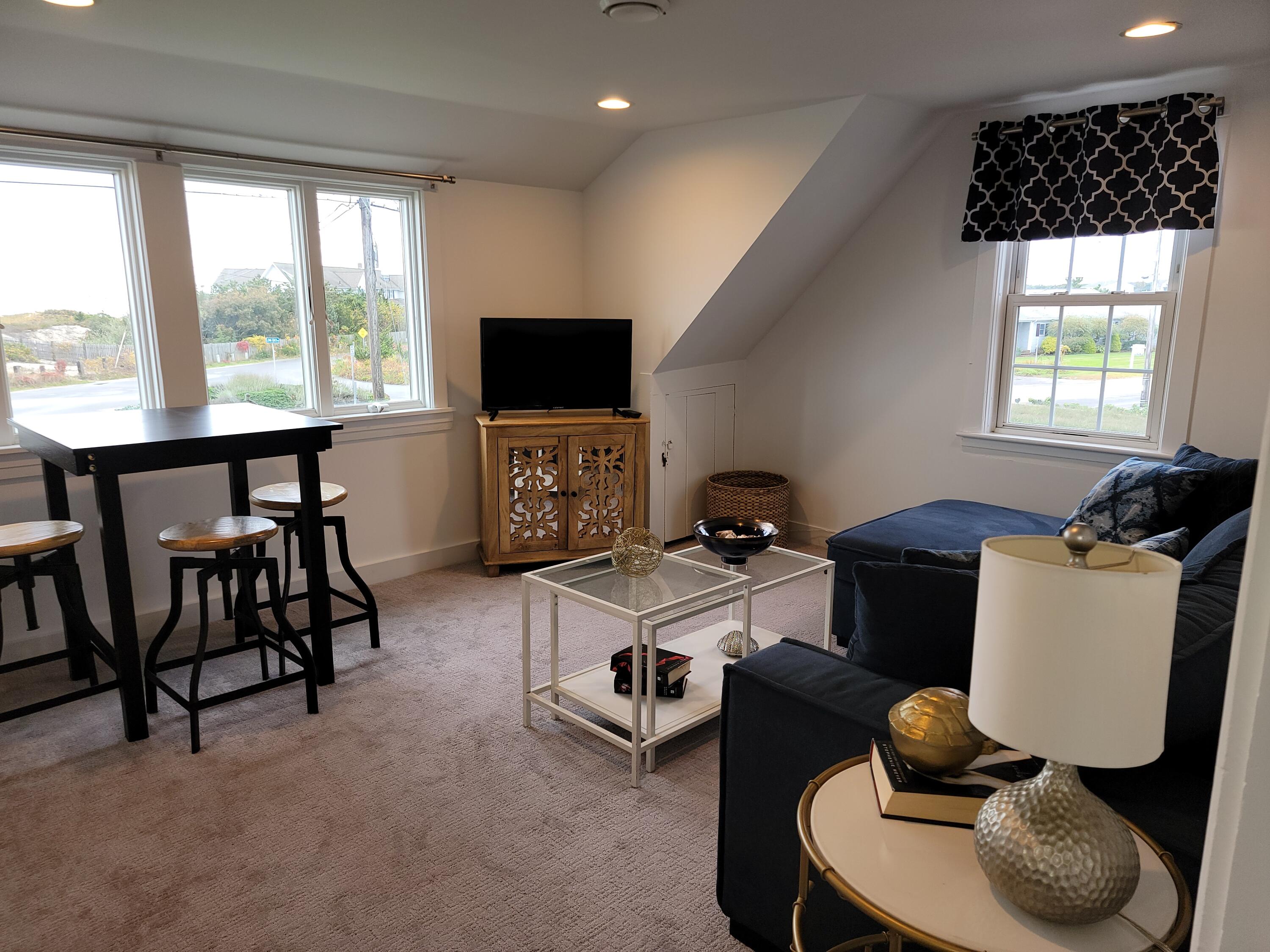 1060 Craigville Beach Road Centerville, MA 02632 - Photo 23 of 50 a work room with furniture and a flat screen tv