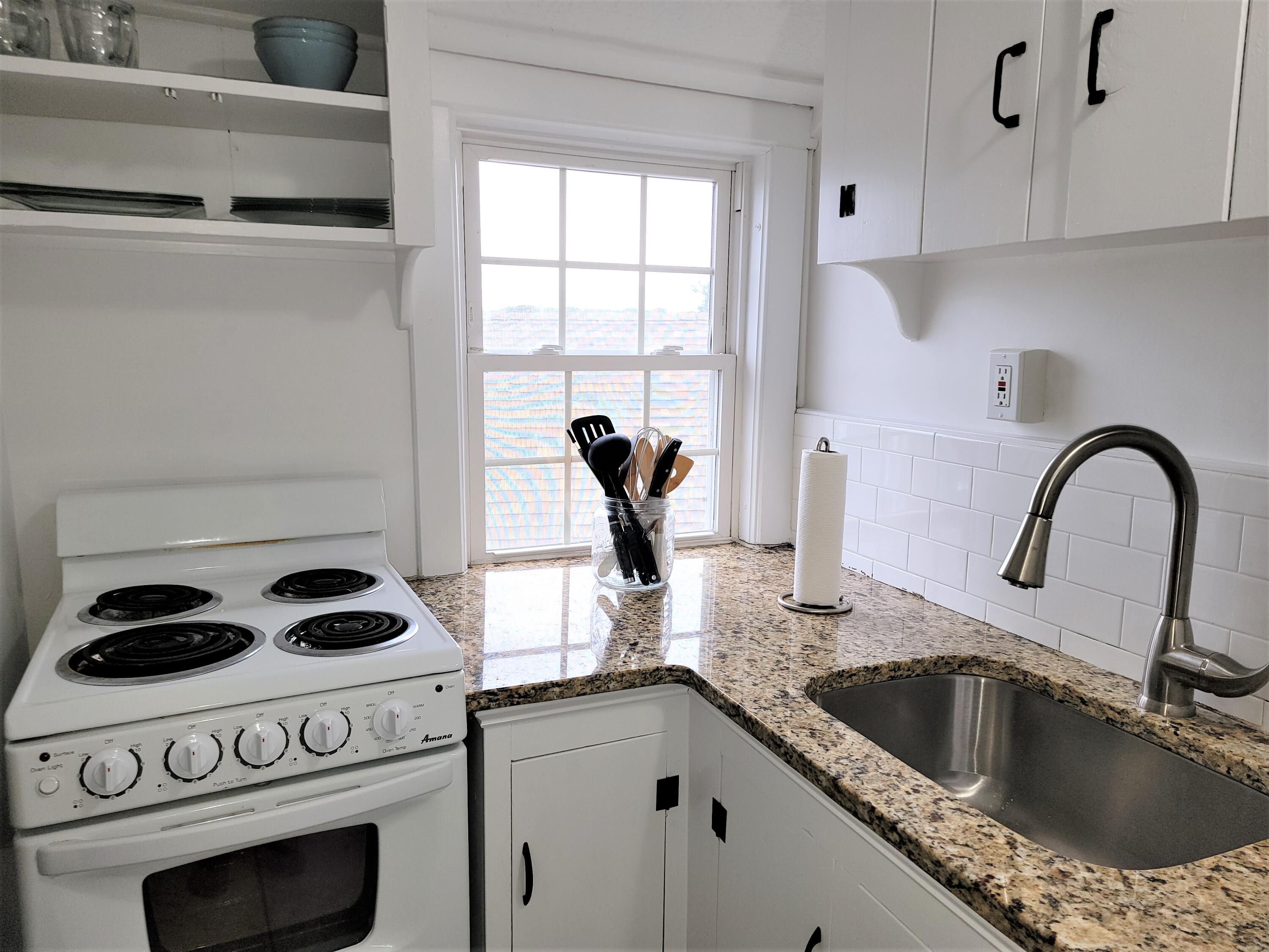 1060 Craigville Beach Road Centerville, MA 02632 - Photo 27 of 50 a kitchen with a stove a sink and cabinets