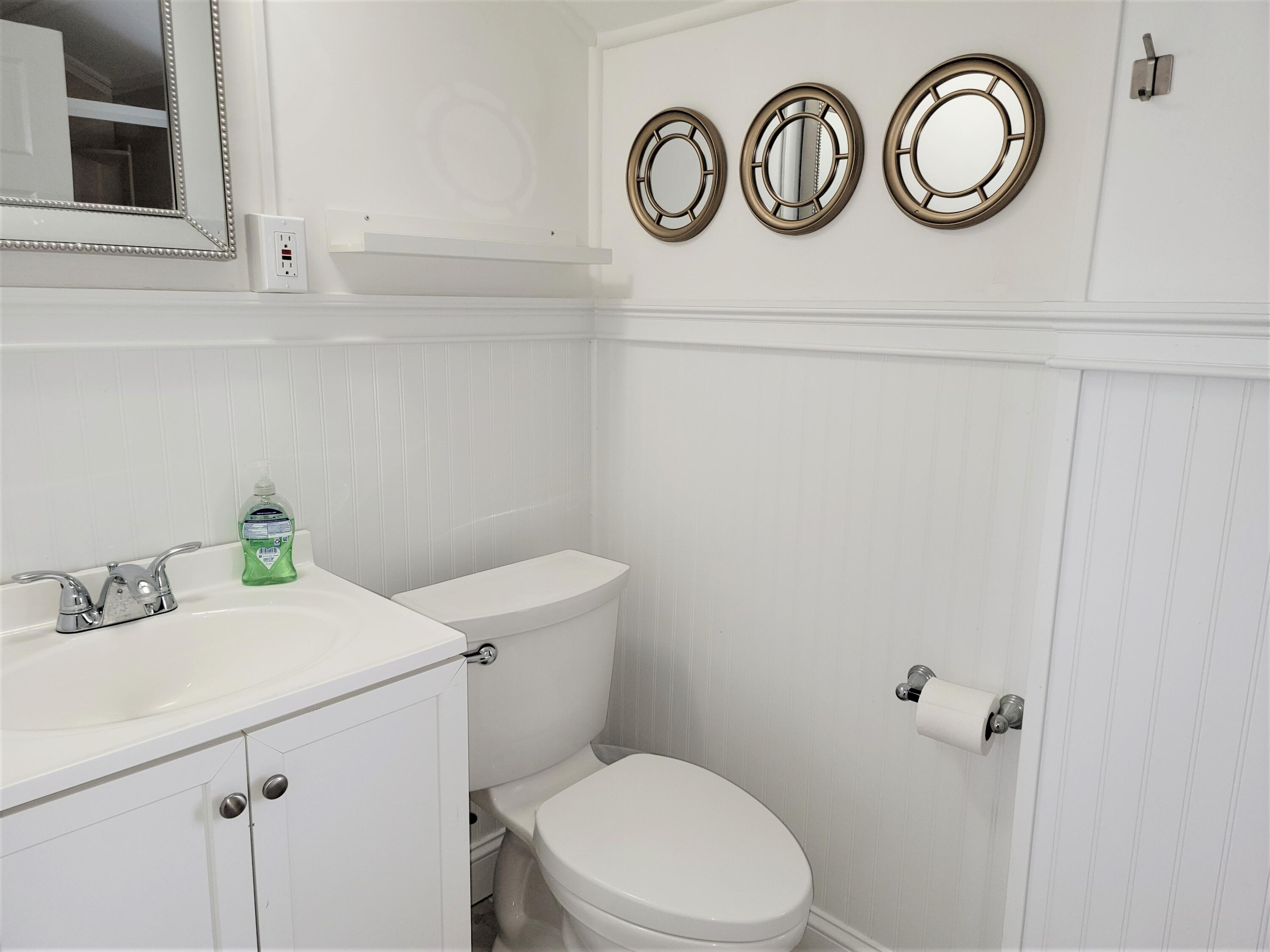 1060 Craigville Beach Road Centerville, MA 02632 - Photo 29 of 50 a bathroom with a sink and a toilet