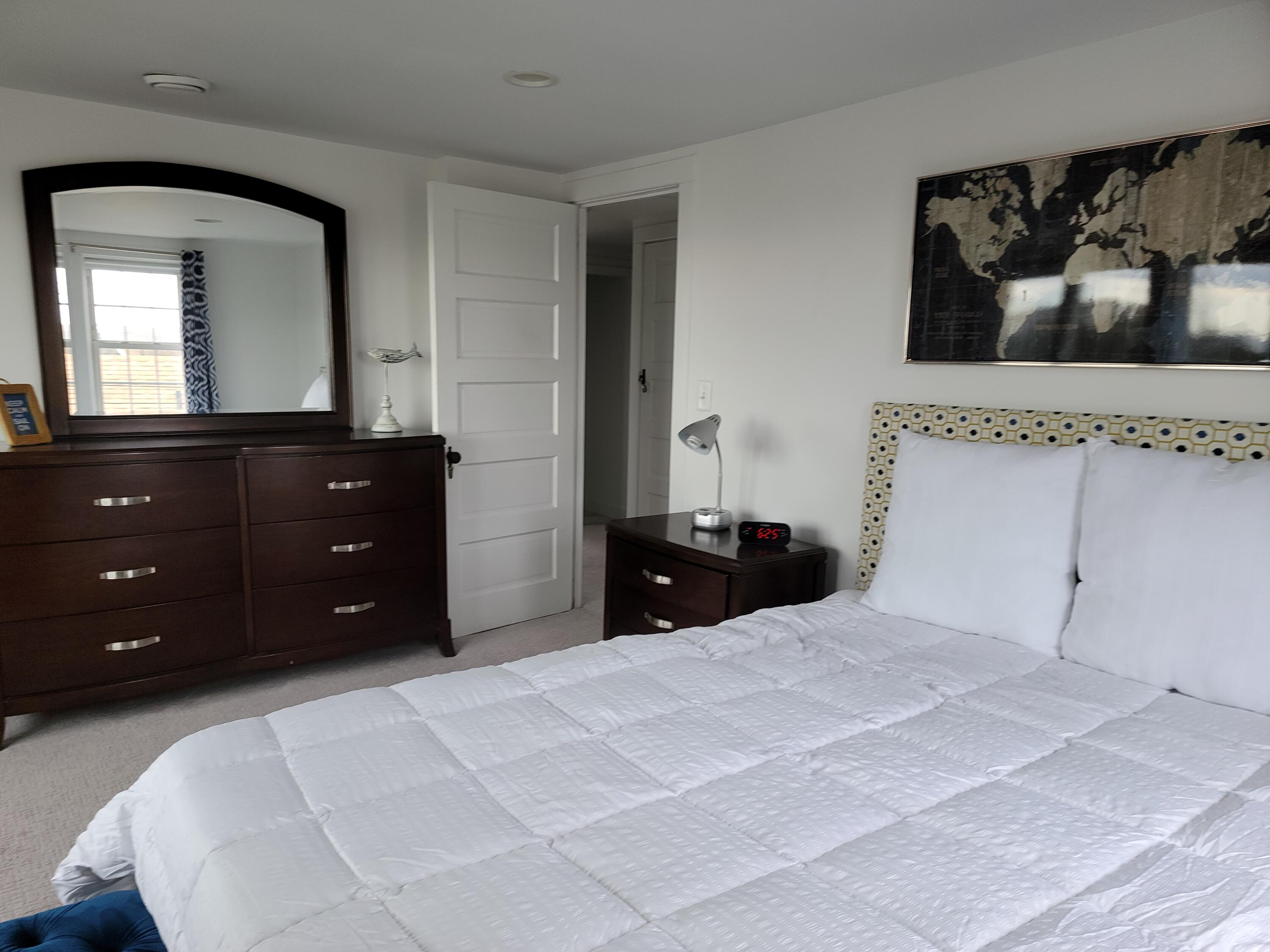 1060 Craigville Beach Road Centerville, MA 02632 - Photo 32 of 50 a bedroom with a bed and a mirror on dresser