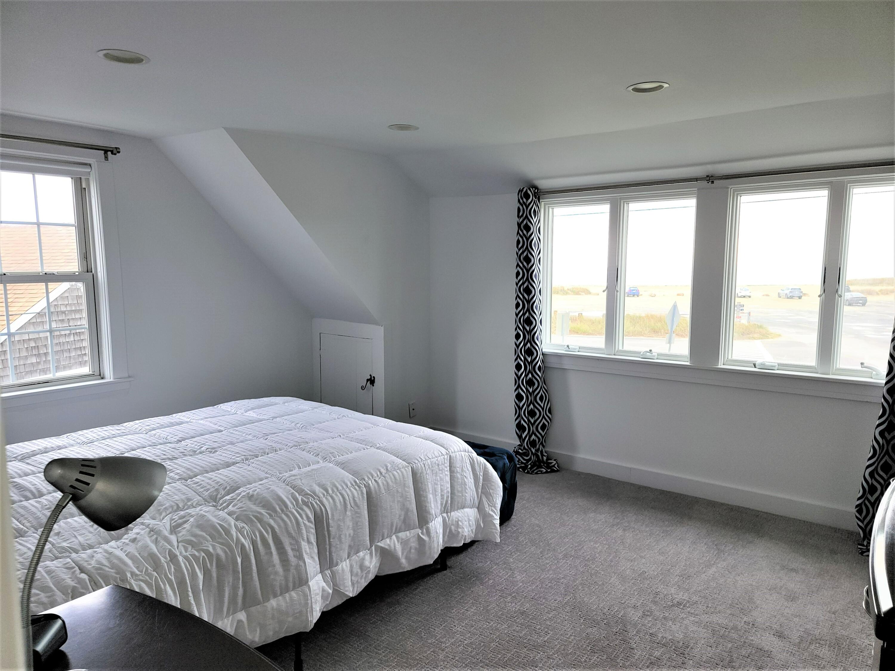 1060 Craigville Beach Road Centerville, MA 02632 - Photo 34 of 50 a bedroom with a bed window and cabinet