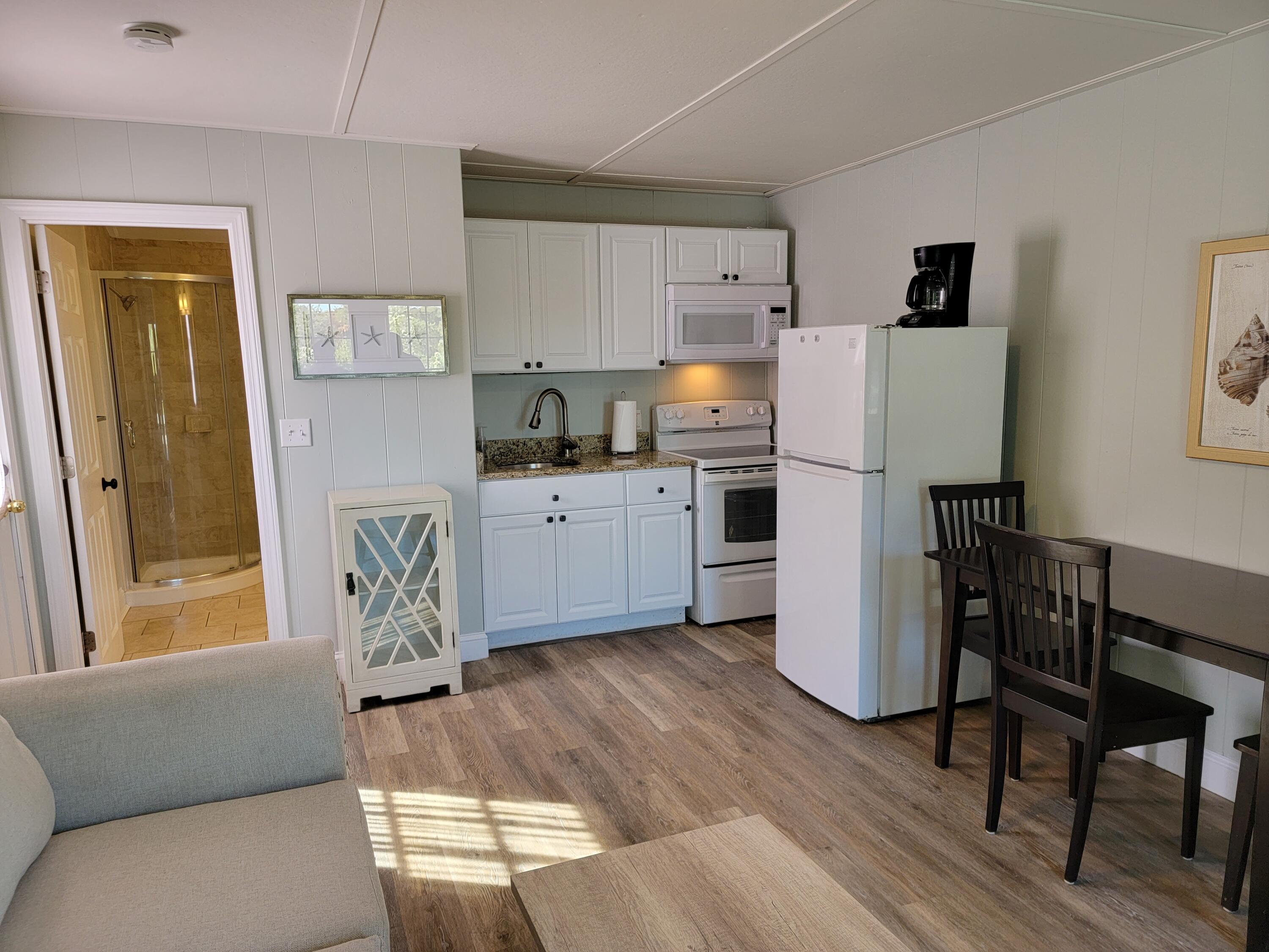 1060 Craigville Beach Road Centerville, MA 02632 - Photo 38 of 50 a living room with stainless steel appliances furniture a refrigerator and a dining table