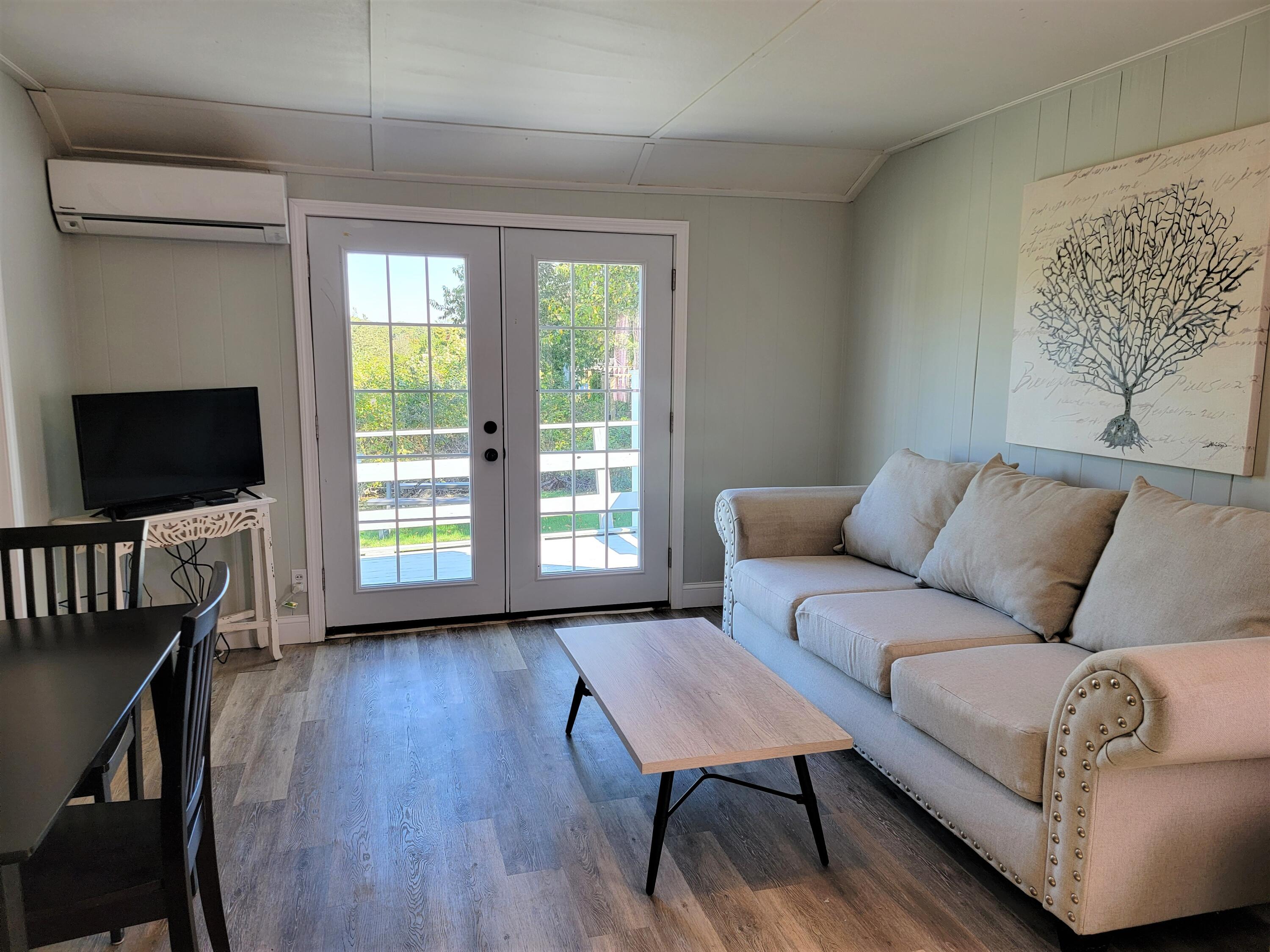 1060 Craigville Beach Road Centerville, MA 02632 - Photo 40 of 50 a living room with furniture and a flat screen tv