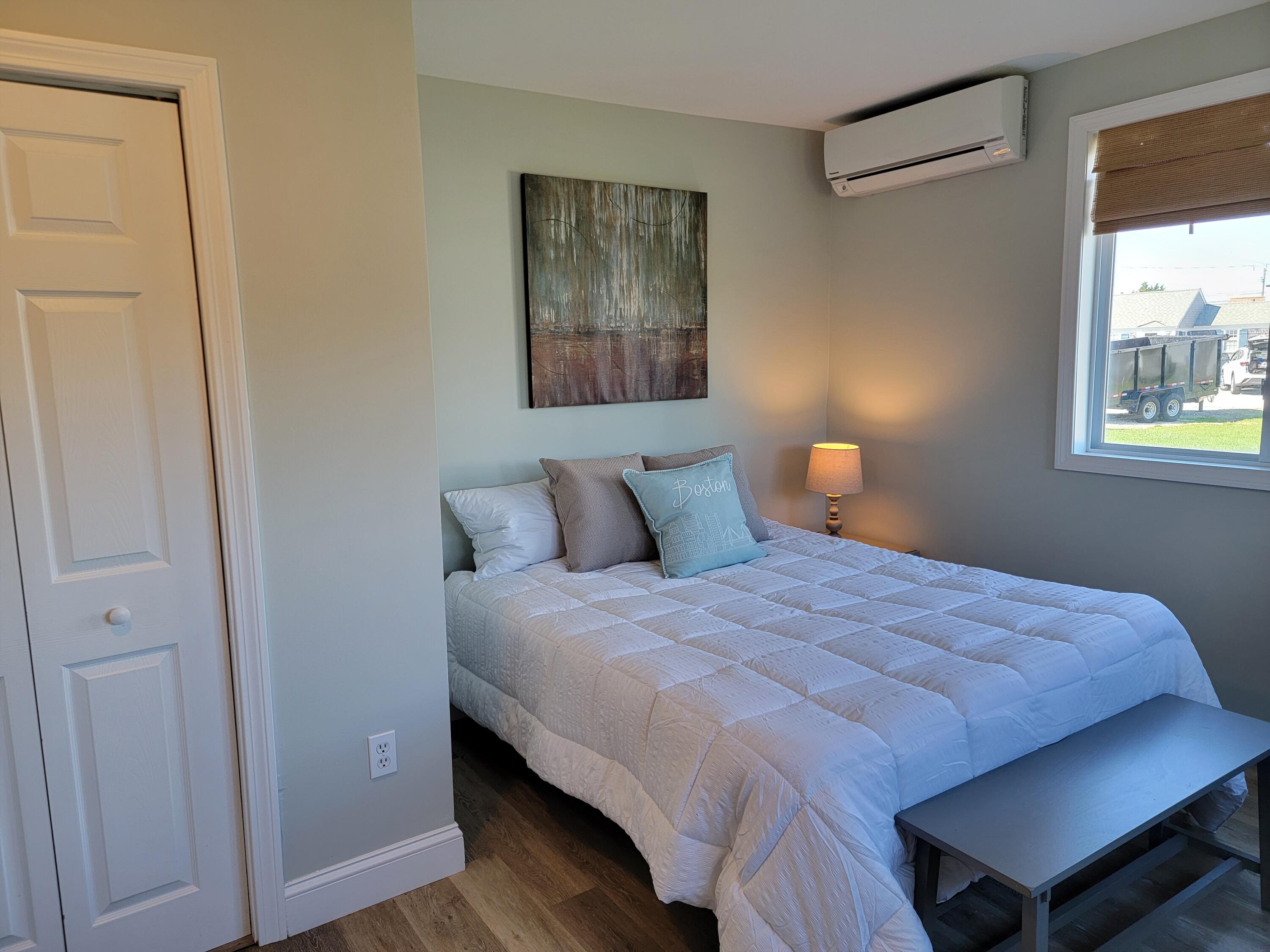 1060 Craigville Beach Road Centerville, MA 02632 - Photo 42 of 50 a bedroom with a bed and wooden floor