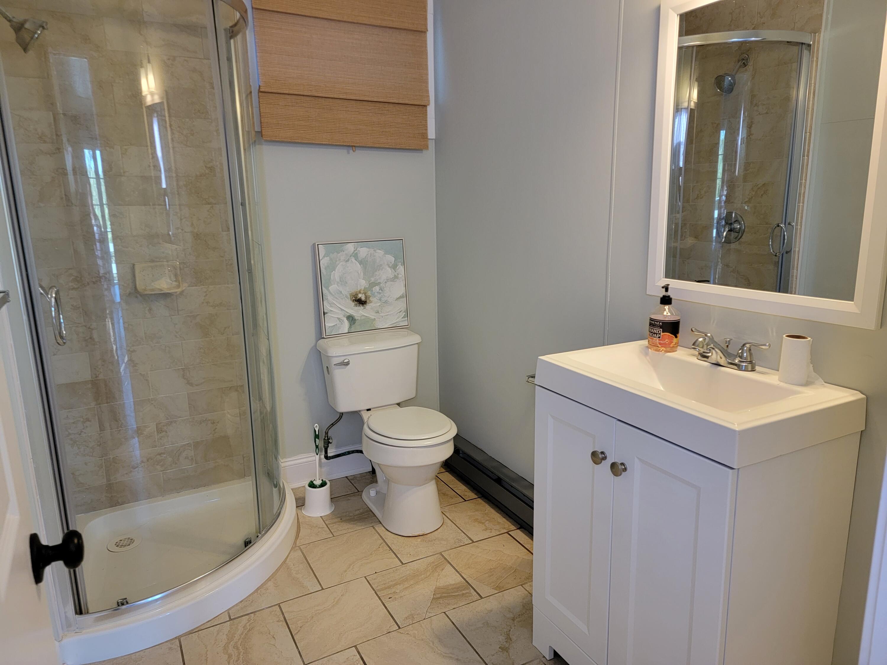 1060 Craigville Beach Road Centerville, MA 02632 - Photo 43 of 50 a bathroom with a sink toilet and shower