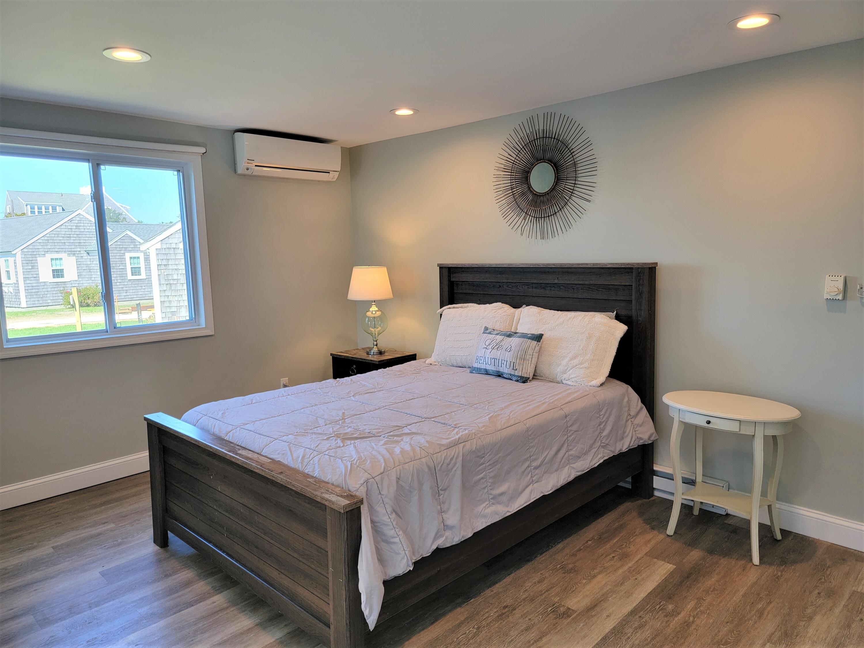 1060 Craigville Beach Road Centerville, MA 02632 - Photo 44 of 50 a bed room with a bed and a chair