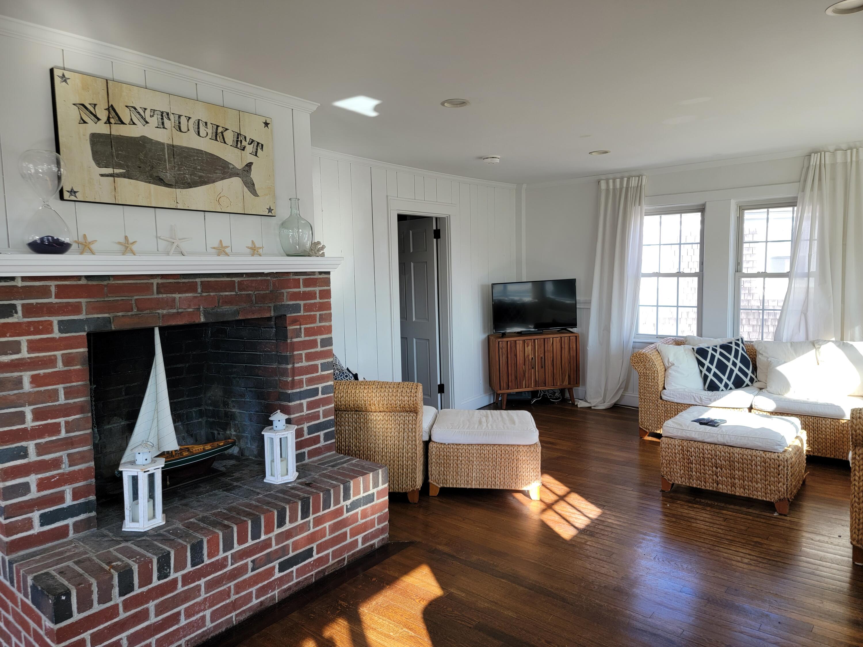 1060 Craigville Beach Road Centerville, MA 02632 - Photo 6 of 50 a living room with furniture and a fireplace