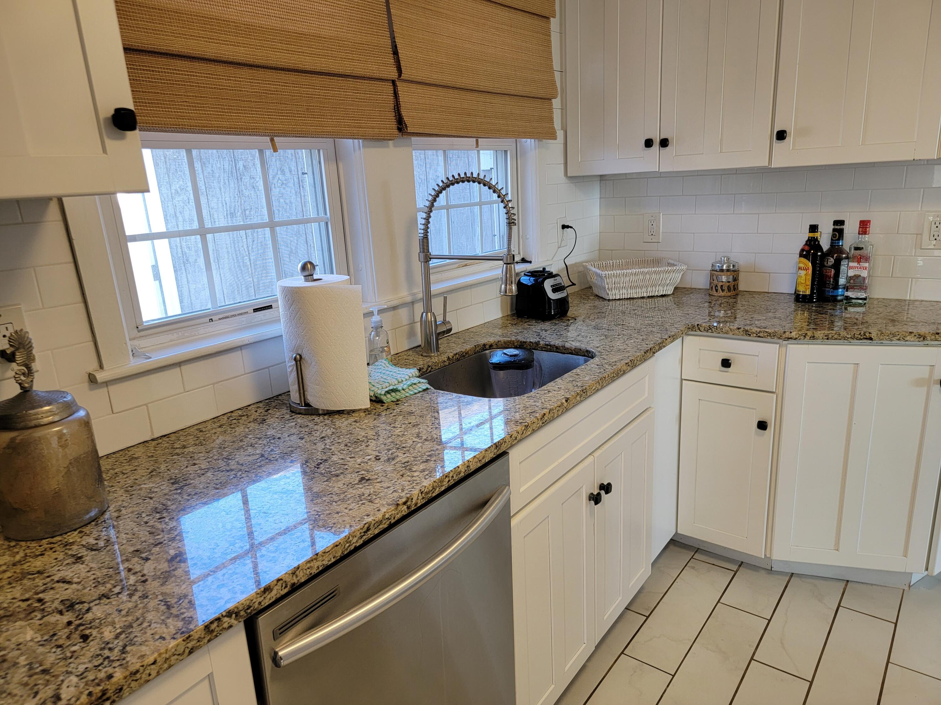 1060 Craigville Beach Road Centerville, MA 02632 - Photo 8 of 50 a kitchen with a sink cabinets and a window
