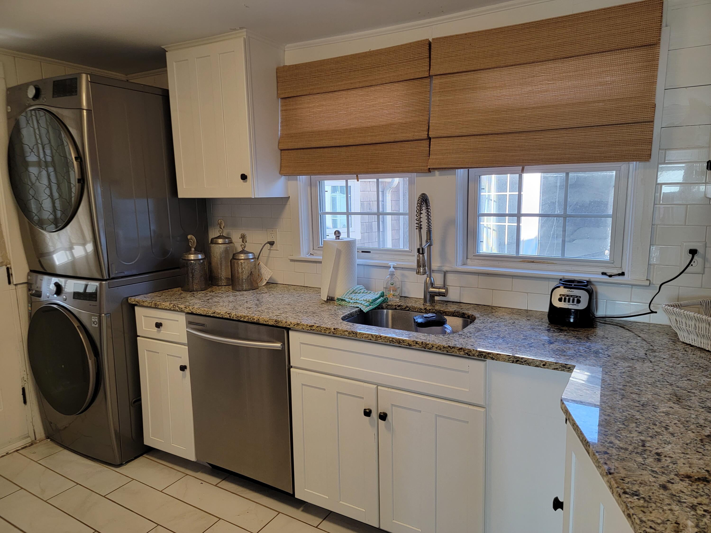 1060 Craigville Beach Road Centerville, MA 02632 - Photo 9 of 50 a kitchen with a sink cabinets and a window
