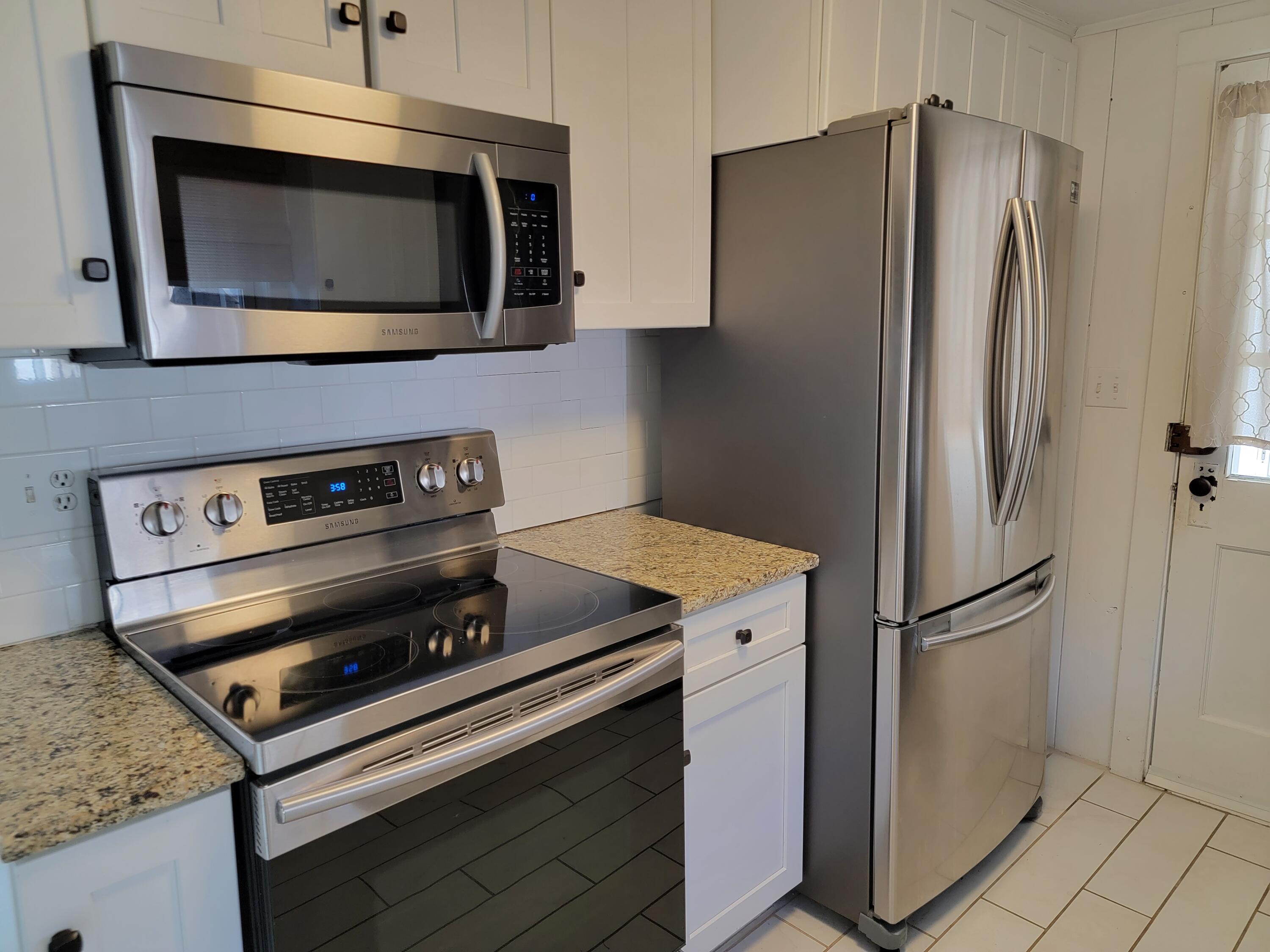1060 Craigville Beach Road Centerville, MA 02632 - Photo 10 of 50 a kitchen with a refrigerator stove and microwave