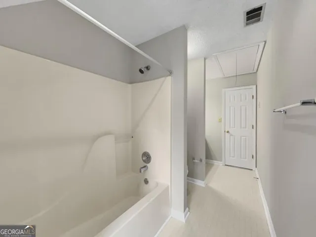 an empty room with a ceiling fan and a window