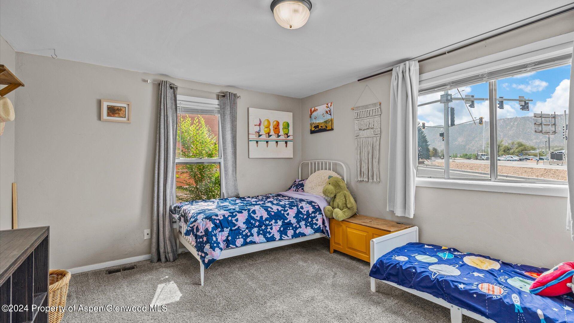 232 East 1st Street Rifle, CO 81650 - Photo 12 of 20 a bedroom with bed and a window