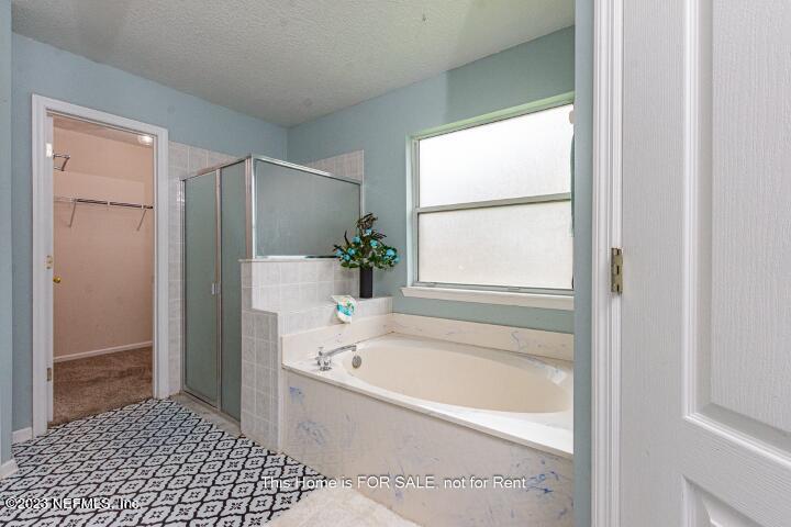 10329 Shelby Creek Road South Jacksonville, FL 32221 - Photo 23 of 41 a bathroom with a bathtub and a shower