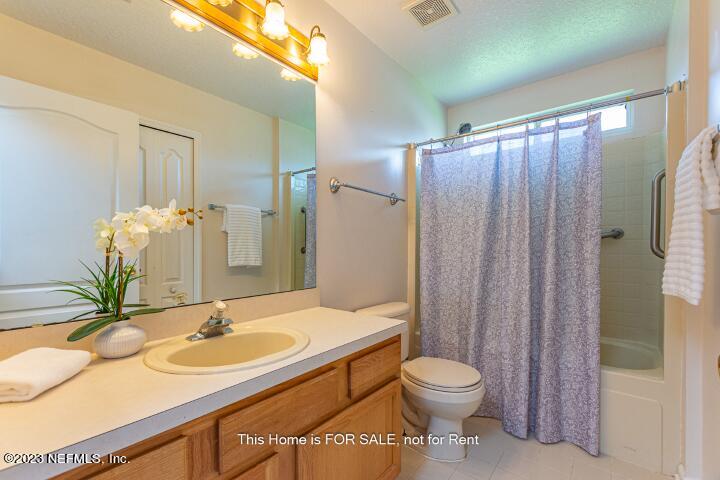 10329 Shelby Creek Road South Jacksonville, FL 32221 - Photo 29 of 41 a bathroom with a sink a toilet and shower