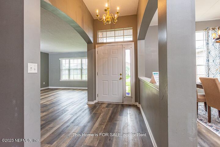 10329 Shelby Creek Road South Jacksonville, FL 32221 - Photo 4 of 41 wooden floor in an empty room with a window