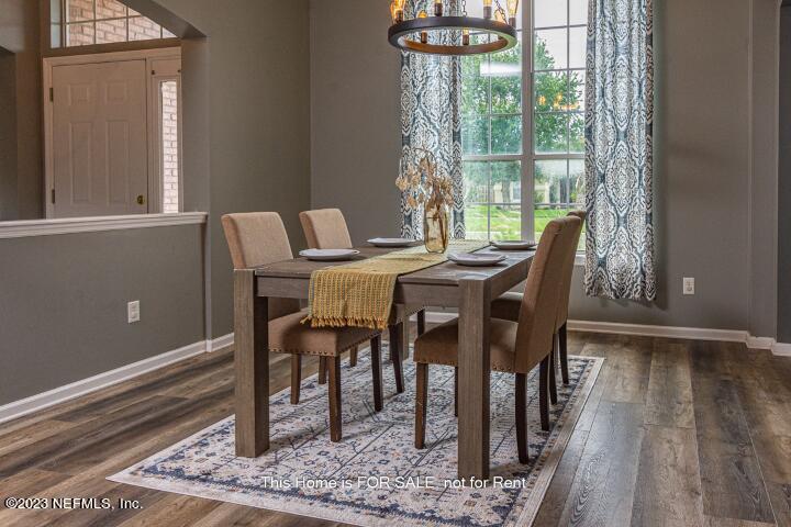 10329 Shelby Creek Road South Jacksonville, FL 32221 - Photo 7 of 41 a view of a dining room with furniture window and wooden floor