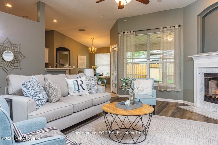 10329 Shelby Creek Road South Jacksonville, FL 32221 - Photo 10 of 41 a living room with patio furniture and a fireplace