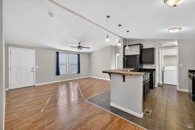 a view of kitchen with refrigerator microwave and stove