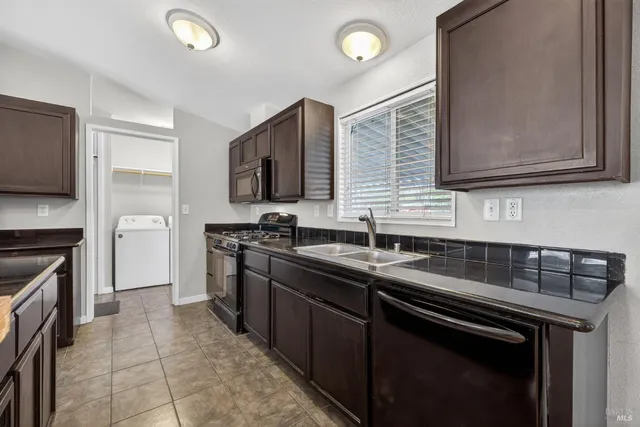 a kitchen with a sink stove and microwave