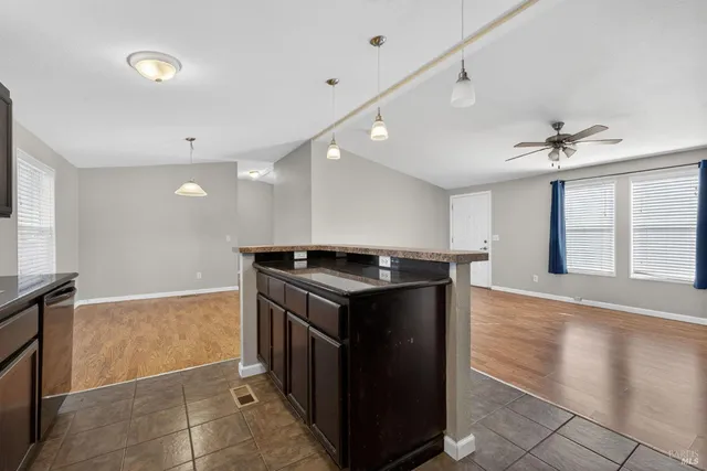 a kitchen with stainless steel appliances granite countertop a stove and a sink