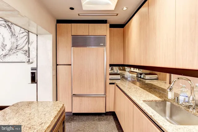 a kitchen with a refrigerator and a sink