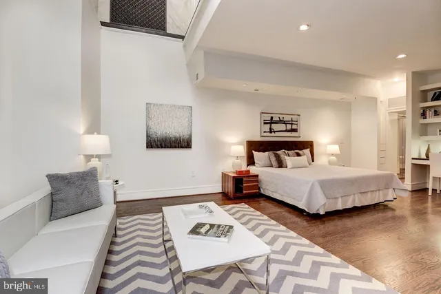 a bedroom with a bed and a couch