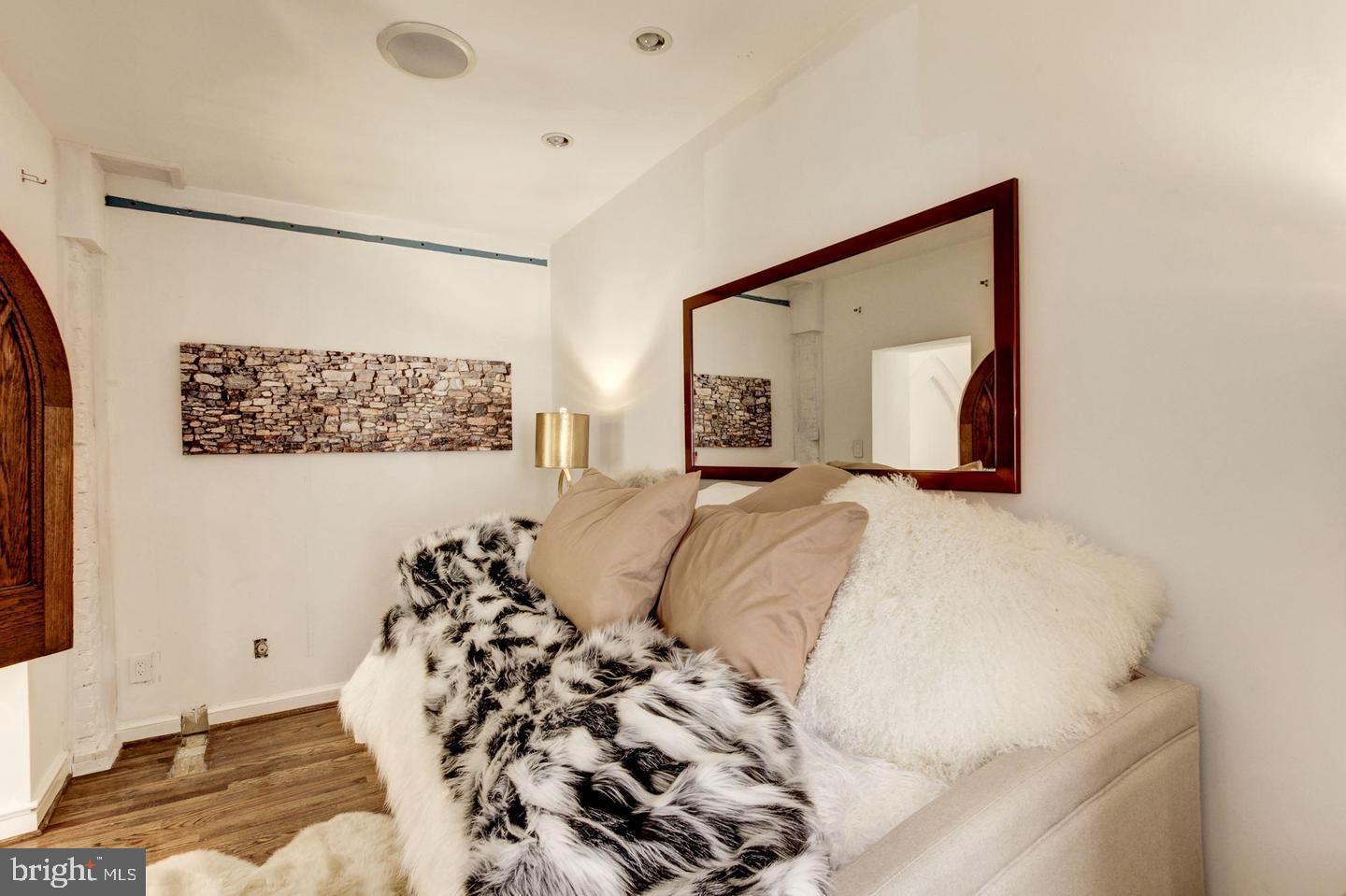 1715 15th Street Northwest, Unit 5 Washington, DC 20009 - Photo 28 of 34 a bedroom with a bed and a mirror