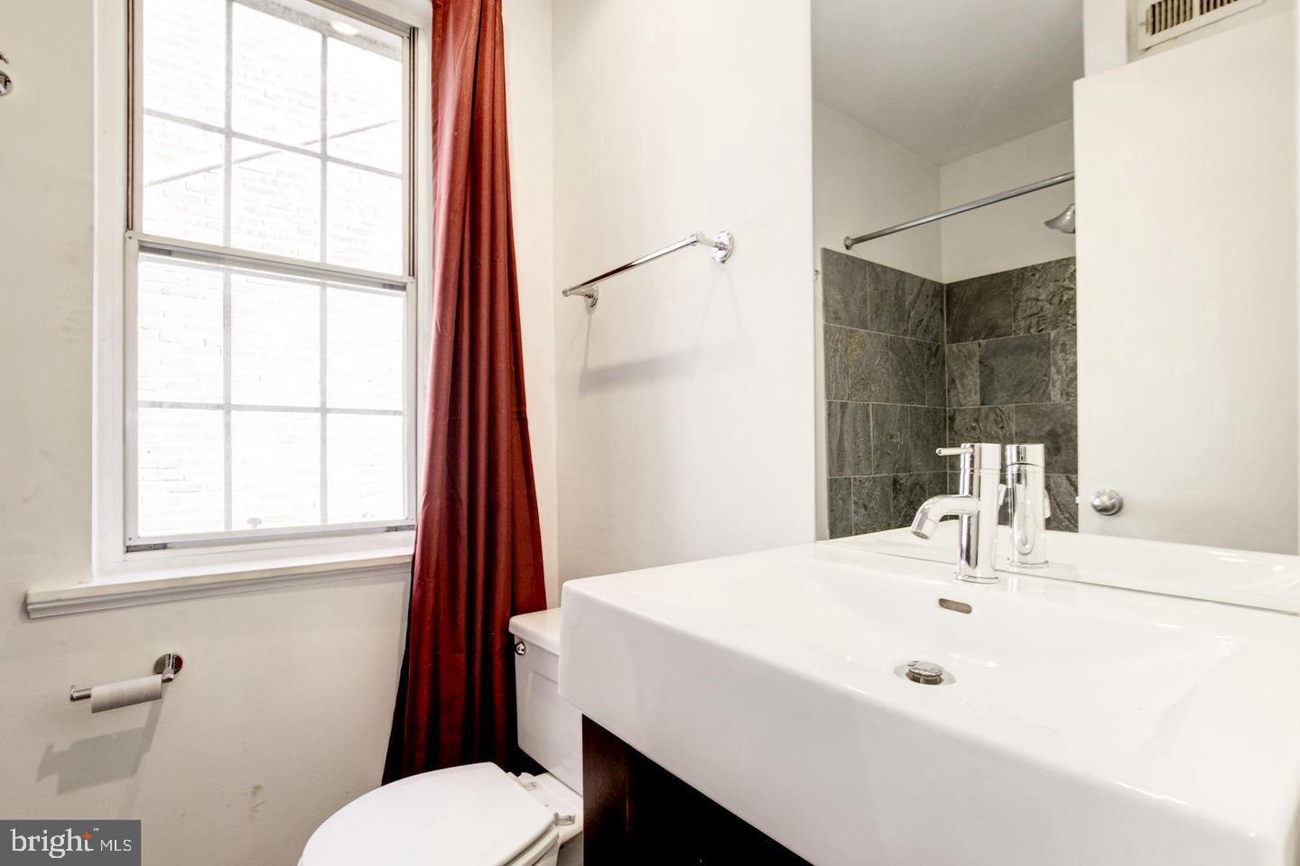 1715 15th Street Northwest, Unit 5 Washington, DC 20009 - Photo 29 of 34 a bathroom with a sink a toilet and tub