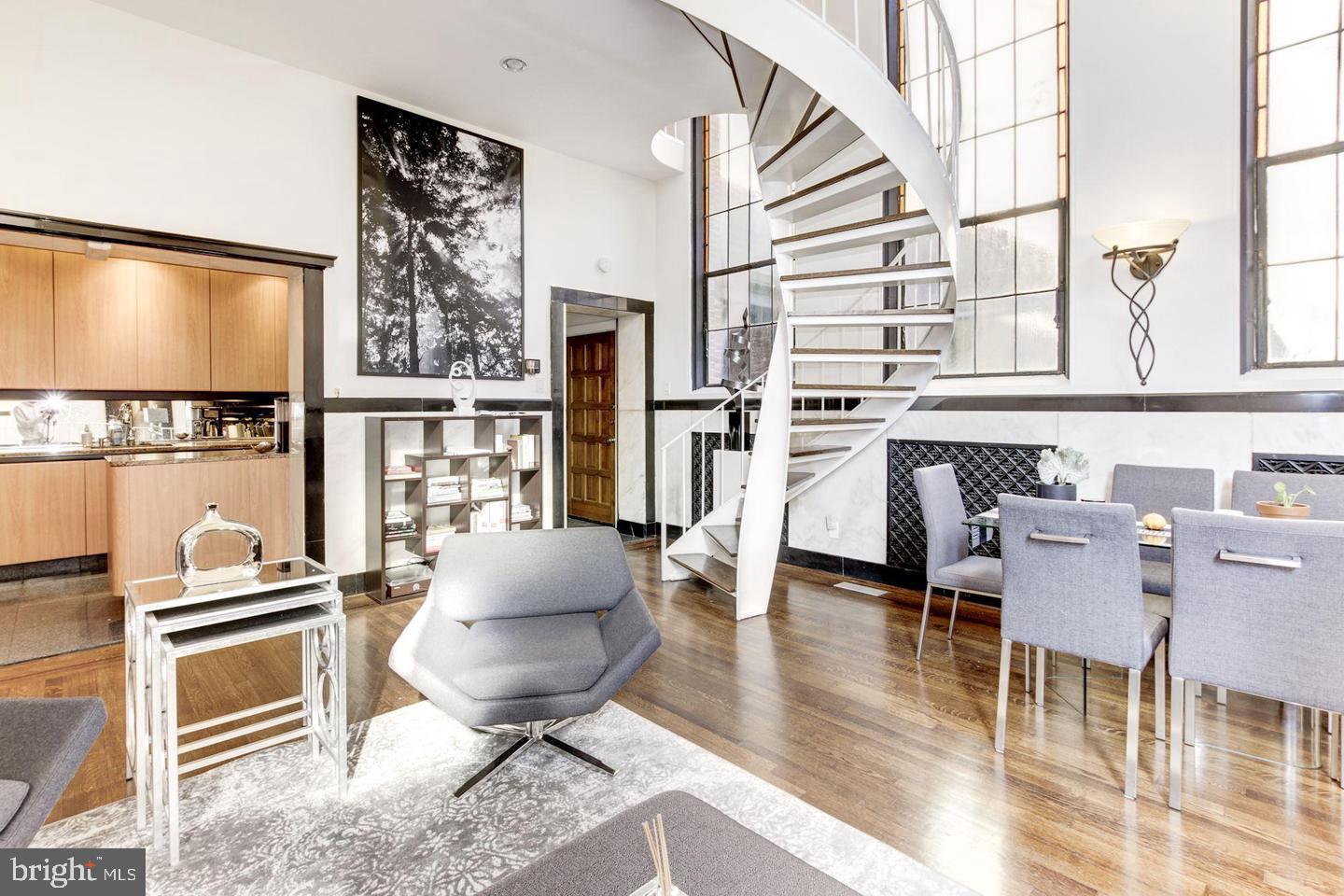1715 15th Street Northwest, Unit 5 Washington, DC 20009 - Photo 7 of 34 a living room with furniture a flat screen tv and a floor to ceiling window