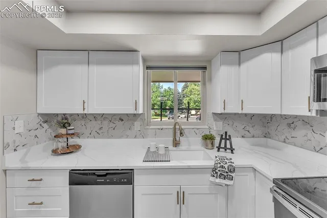 a kitchen with a sink cabinets and window