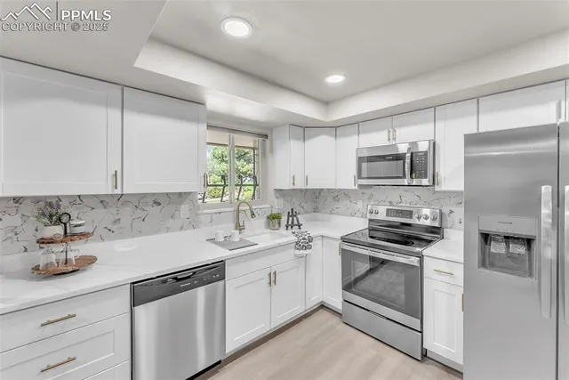 a kitchen with sink a microwave and cabinets