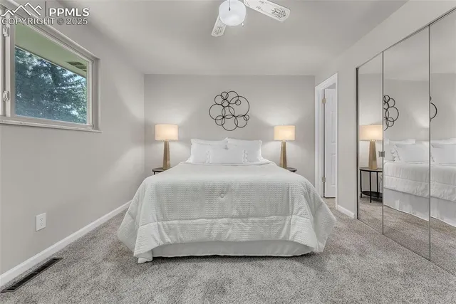 a bedroom with a bed and painting on the wall