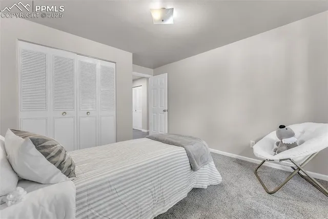 a bedroom with a bed and chair