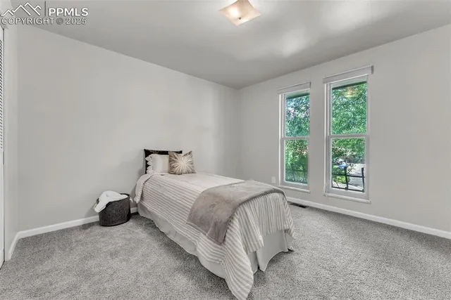 a bed room with a bed and a window