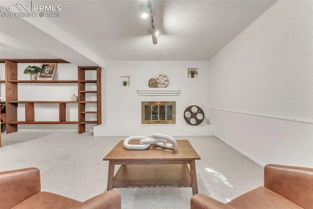 a living room with furniture and a clock
