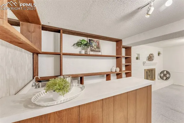 a kitchen with stainless steel appliances a sink a window and cabinets