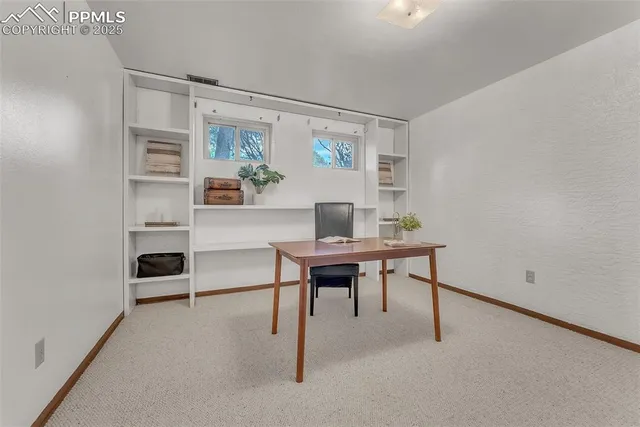 a view of a workspace with furniture